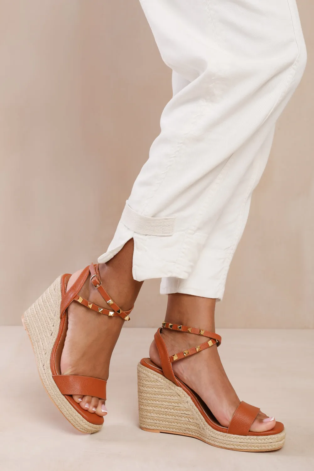 TEXAS WIDE FIT CROSS OVER ANKLE STRAP WITH STUDD DETAIL ESPADRILLE WEDGES IN TAN FAUX LEATHER